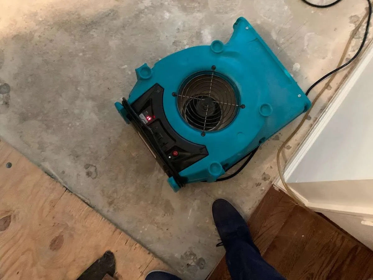 Air mover drying subfloor during Leak Detection & Repair in Columbia